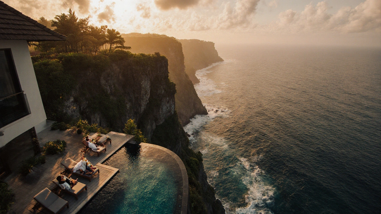 Helikopter terbang di atas tebing Bali, vila mewah dengan kolam menghadap laut saat senja.